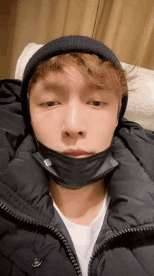a man wearing a black mask and a beanie
