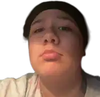 a woman wearing a black hat and a nose ring looks at the camera