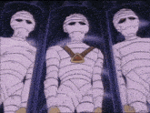 a cartoon of three mummy 's in a row