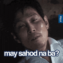 a man in a white shirt is laying down with the words may sahod na ba written above him