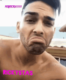 a shirtless man with a beard making a funny face with rickystas written in pink on the bottom