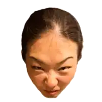 a close up of a woman 's face with a very angry expression