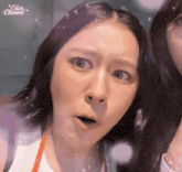 a close up of a woman making a funny face with her mouth open