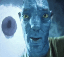 a man with blue skin and yellow eyes is looking at a donut in the background .