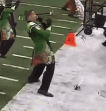 a man in a green uniform is standing in front of a red cone that says 40 on it