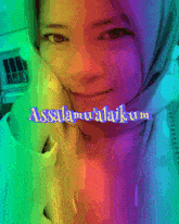 a woman wearing a hijab with a rainbow colored background that says ' assalamu'alaikum ' on it