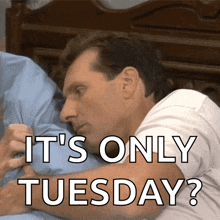 a man laying on a bed with the words " it 's only tuesday " below him