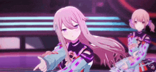 two anime girls are standing next to each other on a stage and one of them is pointing at the camera .