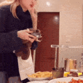 a woman is standing in front of a plate of french fries and a plate of food
