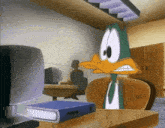 a cartoon duck is sitting at a desk with a binder on it