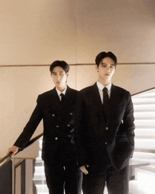 two men in suits and ties stand next to each other
