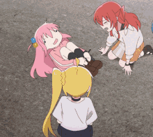 a girl with pink hair is laying on the ground with other girls