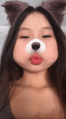 a girl with a dog face paint on her face
