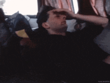 a blurry photo of a man sleeping with the nzoz archive written on the bottom