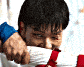 a man with a bloody eye is holding another man 's shirt in his hands .