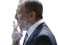 a man with glasses is smoking a cigarette