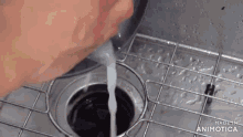 a person is pouring water into a kitchen sink .