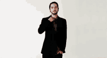 a man in a suit is making a middle finger gesture .