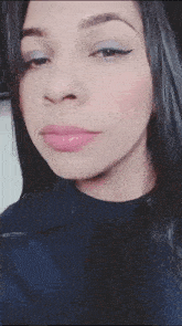 a close up of a woman 's face with long black hair