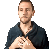 a man wearing a blue sweater with the word mcdh on the bottom right