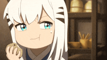 a girl with white hair and blue eyes is holding a cookie in her hand