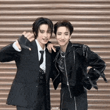 two men posing for a picture with a gif written on the bottom right