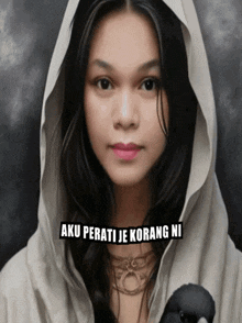 a woman wearing a white hooded cape holds a black bird with aku perati je kurang ni written on the bottom