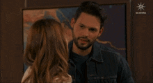 a man and a woman are looking at each other with the words las estrellas on the bottom right