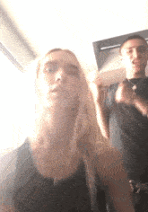 a man and a woman are posing for a picture