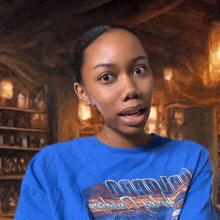 a woman wearing a blue shirt that says orlando