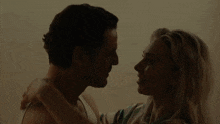 a man and woman are looking into each others eyes