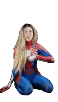 a woman in a spiderman costume is sitting on the floor with her arms outstretched