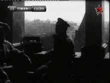 a black and white photo of a man sitting in front of a window with the date march 19 1915