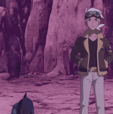 a man and a girl are standing next to each other in front of a rock wall