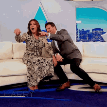 a man and a woman are sitting on a couch with the word harry on the floor