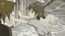 a girl with angel wings reaches out to touch a man 's face