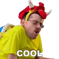 a man wearing glasses and a yellow shirt with the word cool written on it