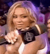 a woman is holding a microphone that says knock