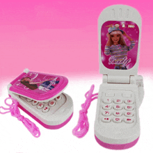 a pink and white flip phone with a barbie doll on it