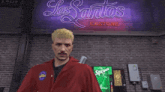 a man in a red jacket with a patch that says ' los santos custom ' on it