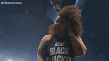 a man with curly hair is wearing a black shirt that says big black jack