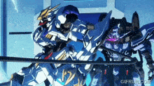 two robots are standing next to each other with gifrun.com in the corner