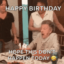 an elderly woman is blowing out candles on a birthday cake and says happy birthday hope this does n't happen today .