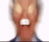 a blurry picture of a man 's face with a surprised look on his face