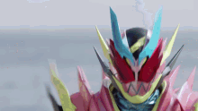 a close up of a cartoon character 's face with a very colorful helmet