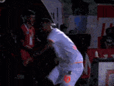 a man in a white jersey with the number 10 on it is dancing