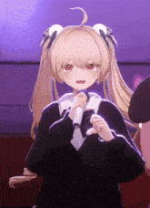 a girl with blonde hair is holding a microphone