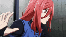 a girl with red hair and a blue shirt that says team on it