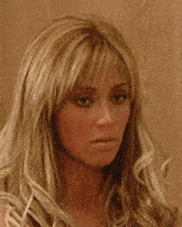 a close up of a woman 's face with a serious look on her face