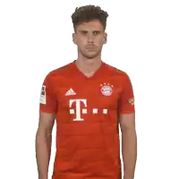 a man wearing a red adidas shirt with the letter t on the front